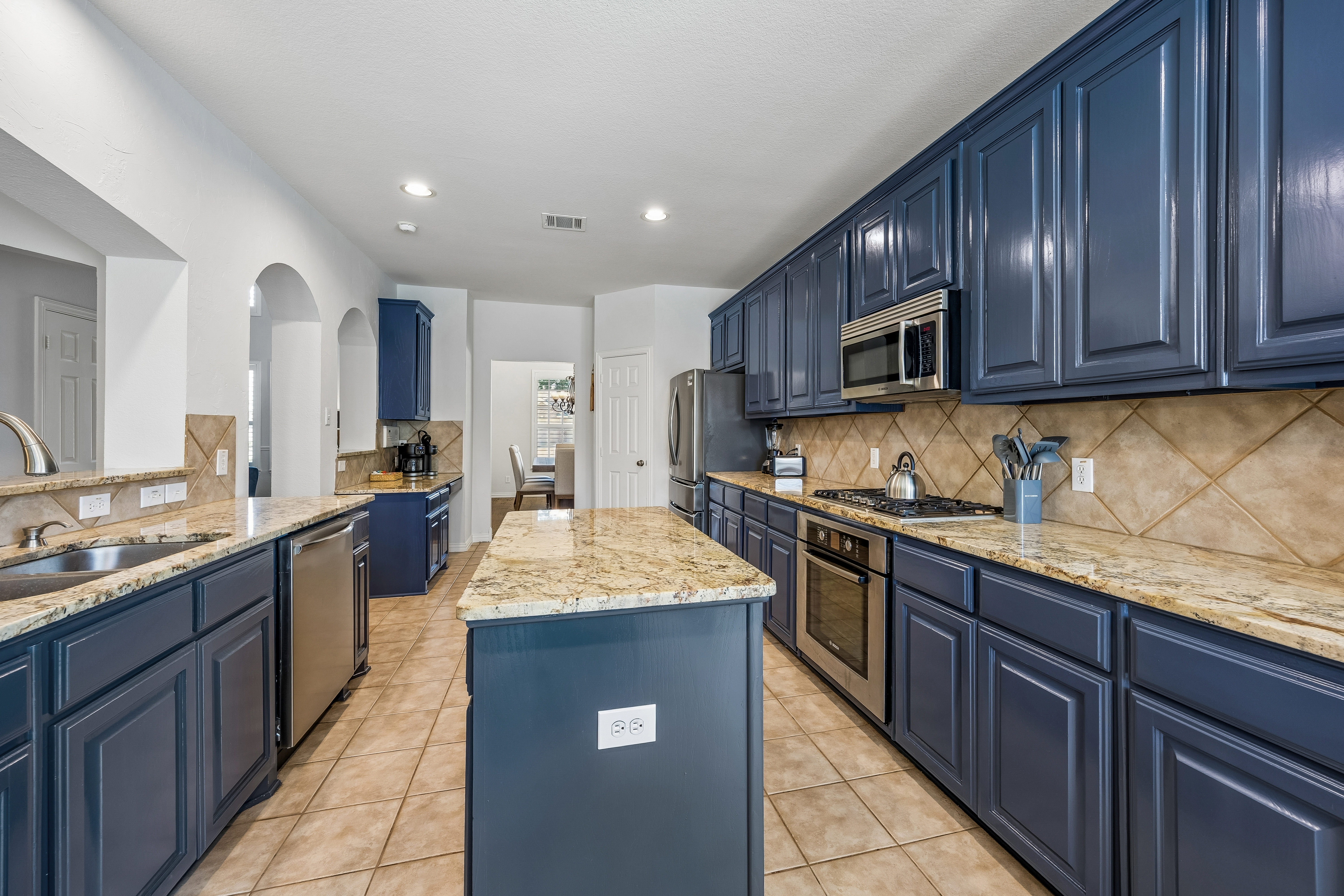 Chef's kitchen with navy cabinets